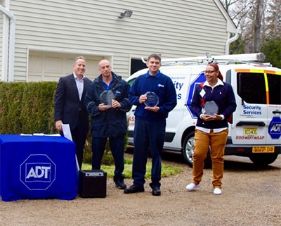 Alan Ferber, President of ADT Residential with ADT Lifesaver Award winners (from left): Service Technician Mike Glove, Installation Technician William Bondarenko and Dispatcher Krista Brandenburg.