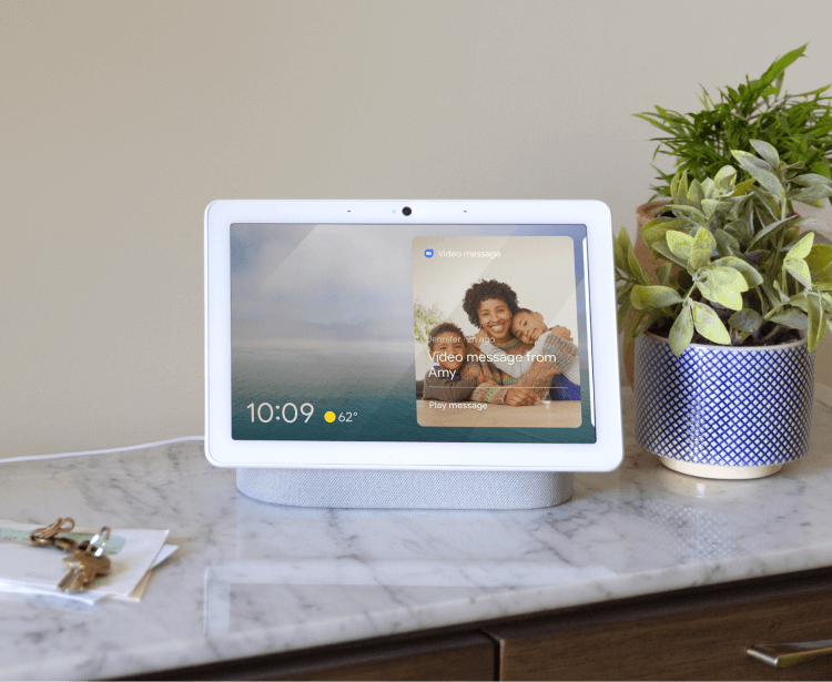 Google Nest Hub (2nd Gen) on a counter next to a plant Google Nest Hub (2nd Gen) on a counter next to a plant