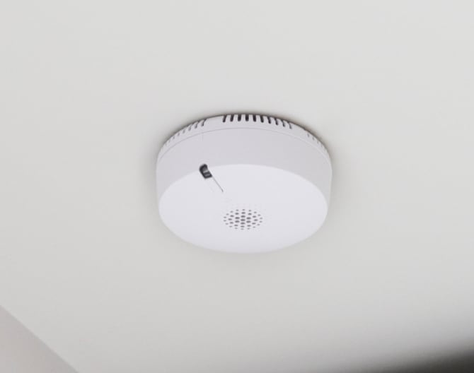 ADT smoke detector on a ceiling in a home