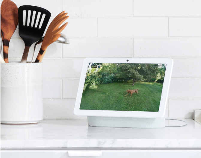 Google Nest Hub Max on a kitchen counter next to kitchen utensils