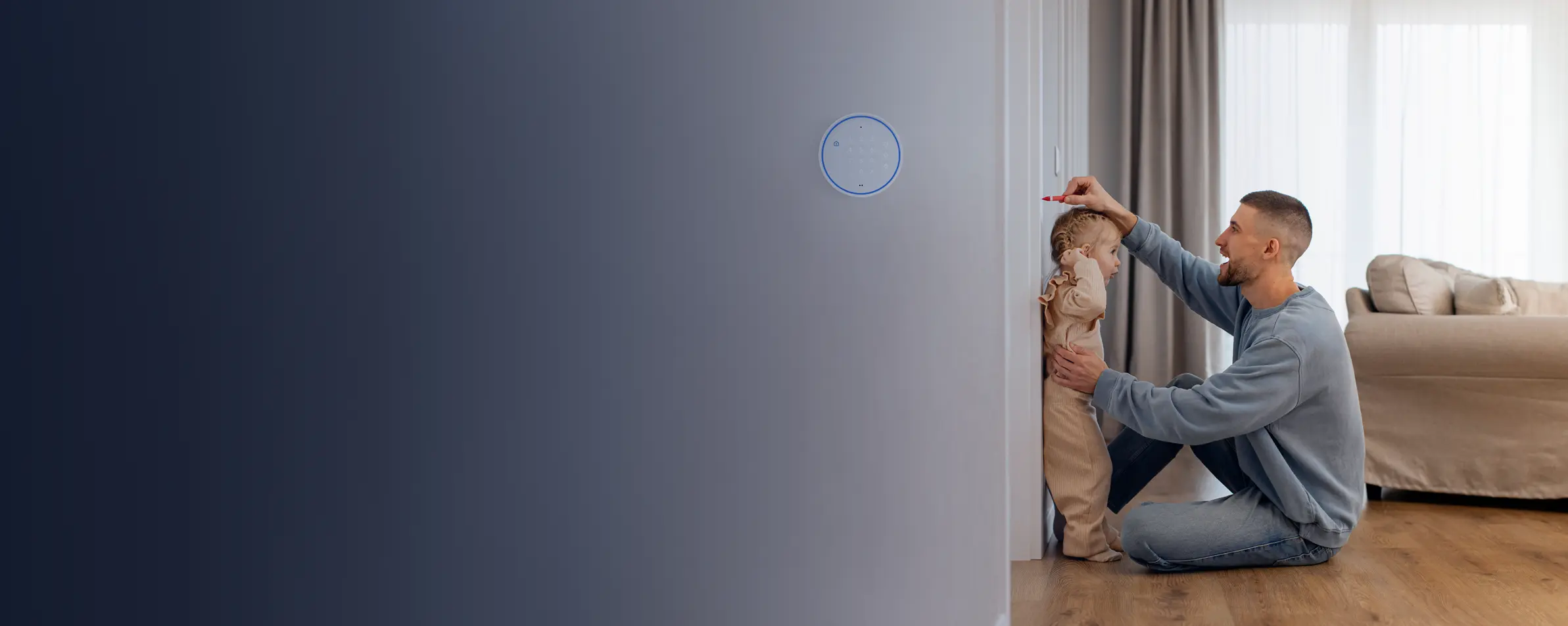 Father marking his toddler's height on a wall beside a home security keypad.