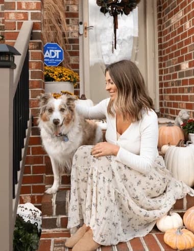 Woman with dog at home protected by ADT