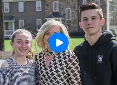 The McManus family standing outside their home