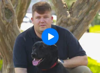 A man with his dog Sophie outdoors