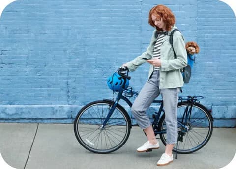 ADT+ app remote control feature — person on a bicycle viewing security controls on their phone