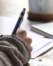 Person writing a moving checklist