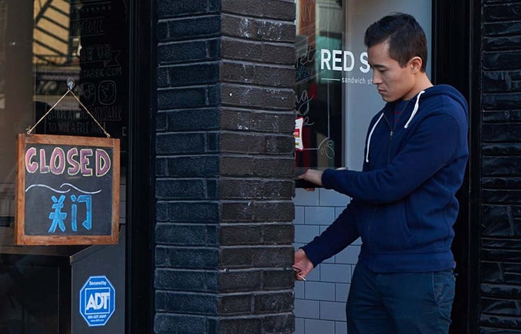 Man opening the door to a business