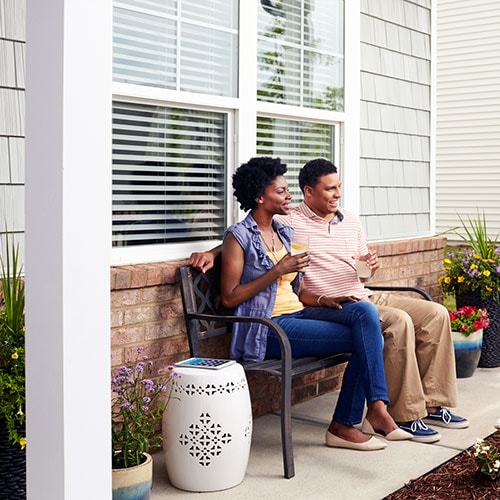 Couple sitting on the front porch.