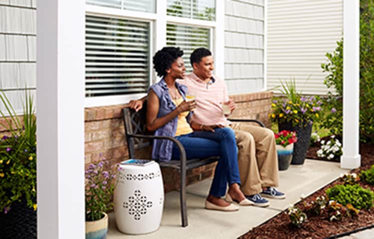Couple sitting on the front porch.