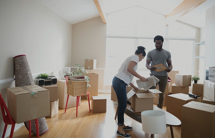 Couple packing their boxes to move Couple packing their boxes to move