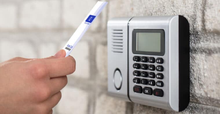 Hand with ID card accessing the keypad