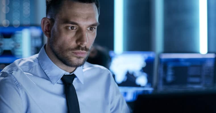 Man with tie looking at computer screen