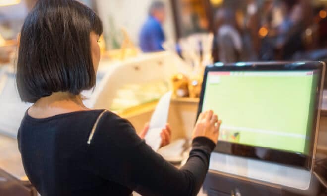 Cashier at cashier machine Cashier at cashier machine