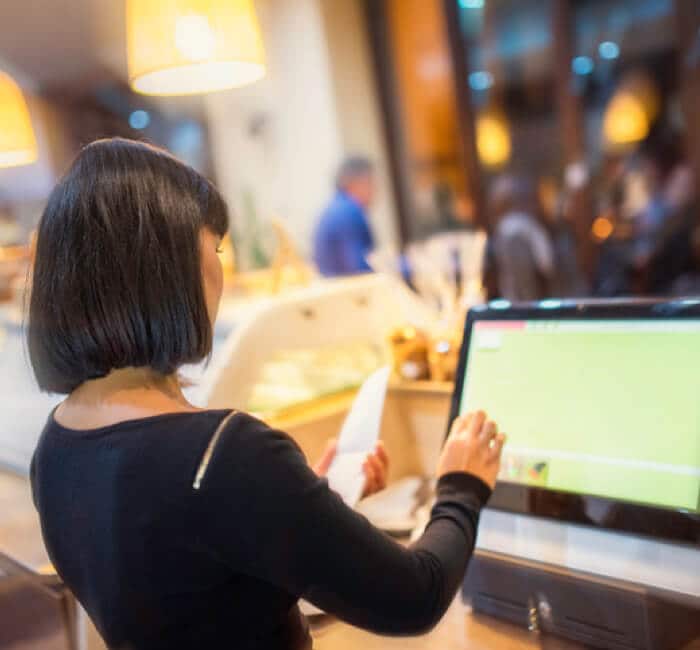 Cashier at cashier machine Cashier at cashier machine