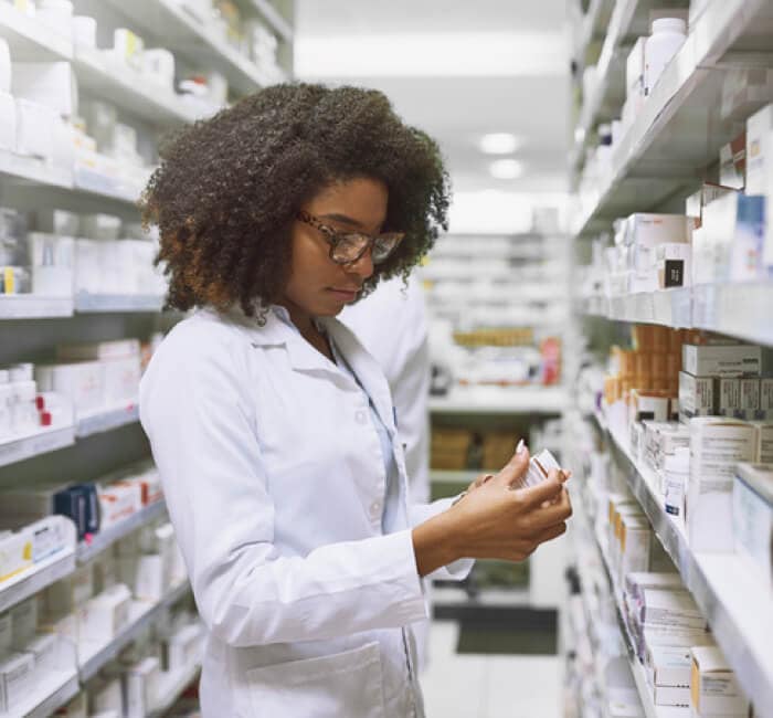 Lab worker examining prescription bottle Lab worker examining prescription bottle