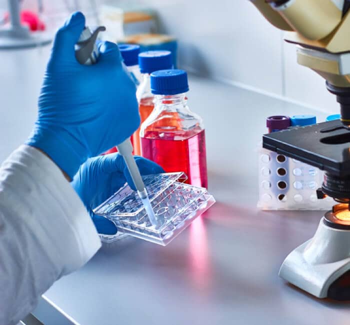 Lab worker measuring doses Lab worker measuring doses