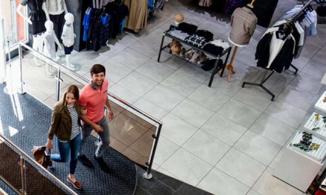 A woman and a man walking into a mall A woman and a man walking into a mall