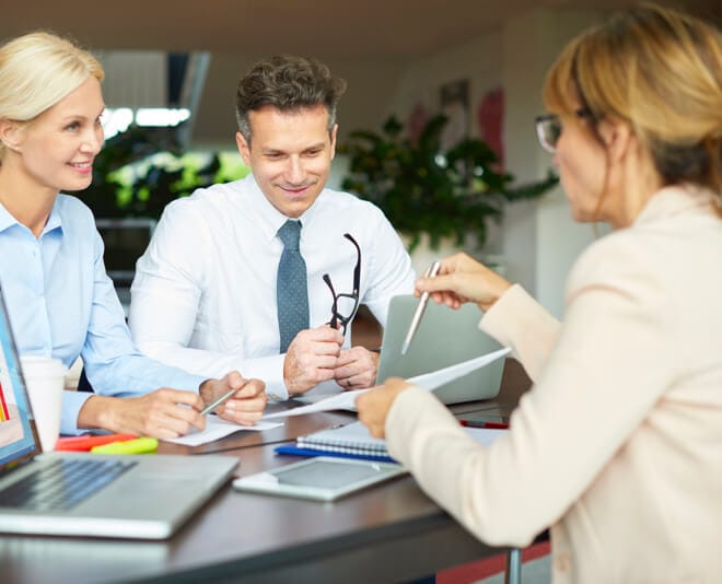 Woman consults with two customers on security solutions Woman consults with two customers on security solutions