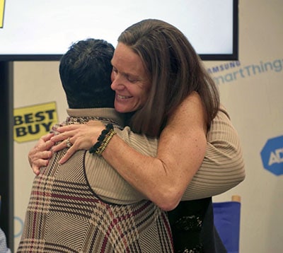 Lawton Carrescia gives the ADT dispatcher, Leatrice Johnson a hug.