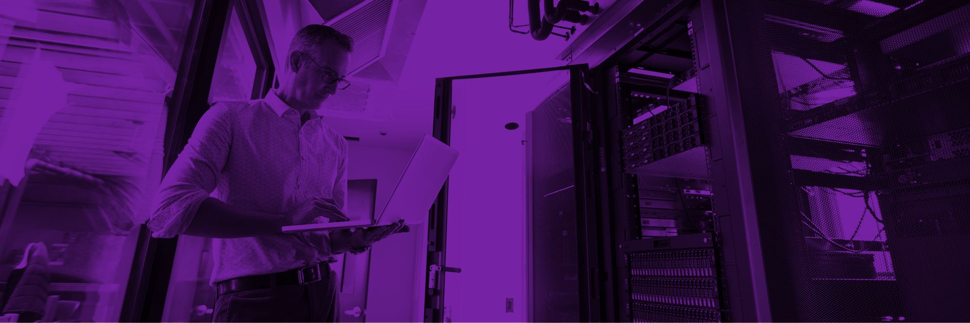 Man with clipboard examining server racks
