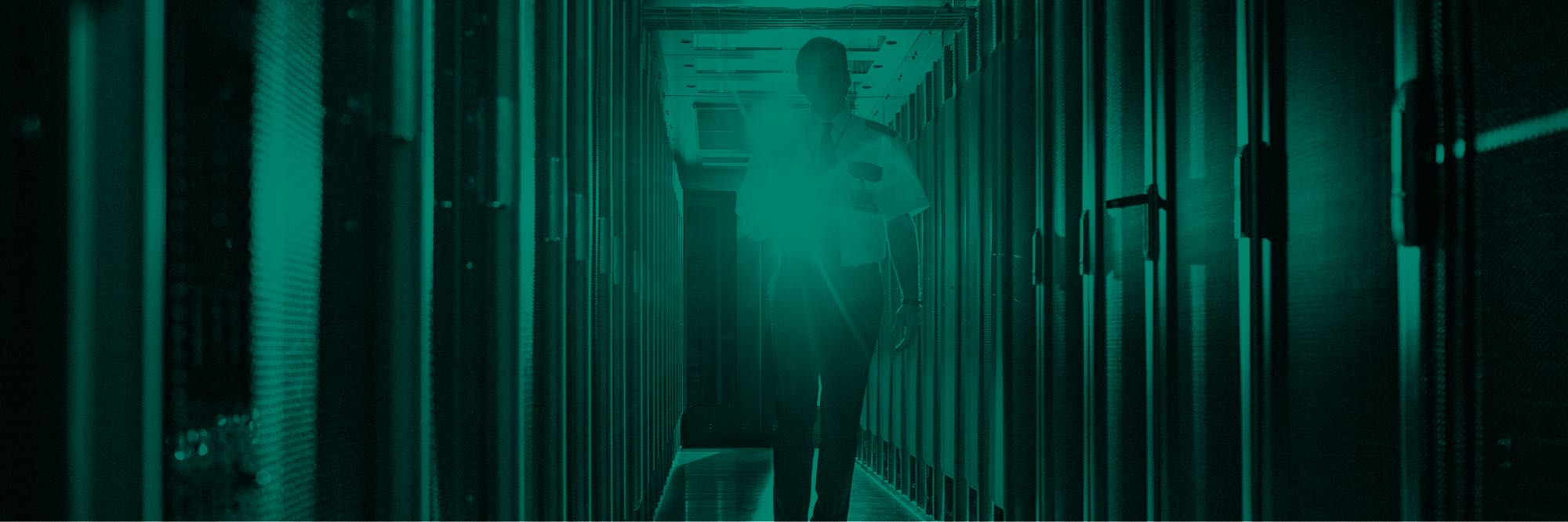 Security guard with flashlight patrolling a server room
