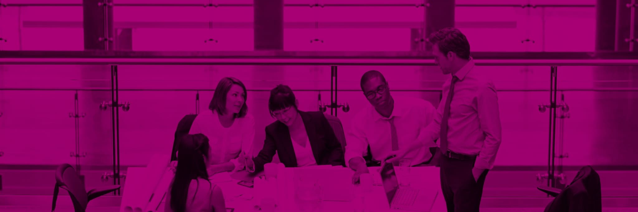 Five people meeting in an open-plan business conference room