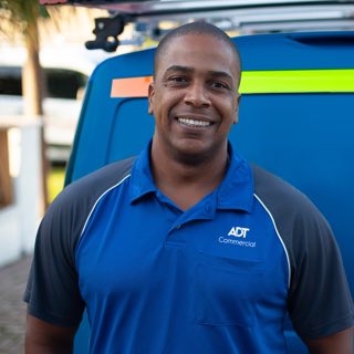 ADT Commercial technician with truck in background