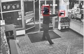 Security camera view of masked man with gun