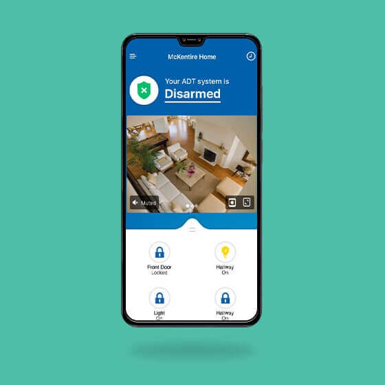 Cellphone against a green background displaying the ADT mobile app