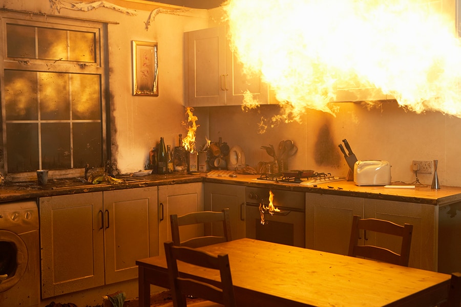 House fire rages in a kitchen at night. House fire rages in a kitchen at night.