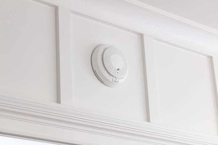 White ADT fire alarm on a white wall. White ADT fire alarm on a white wall.
