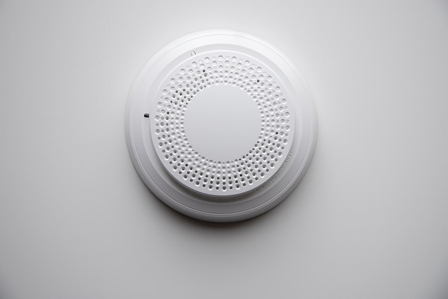 White ADT Smoke Detector on white wall.