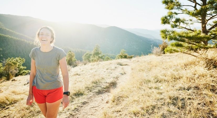 15 Things you Should Know Before Moving to Colorado Woman smiling and laughing on a hike in Colorado