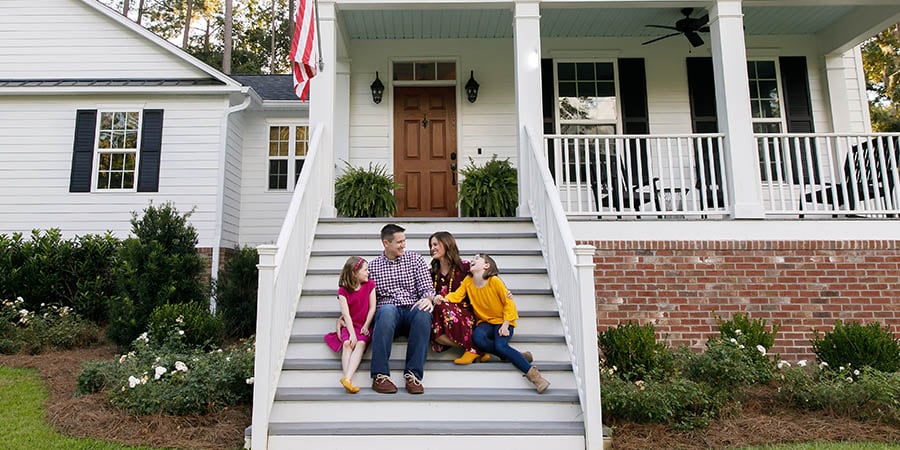 family sitting on the front porch