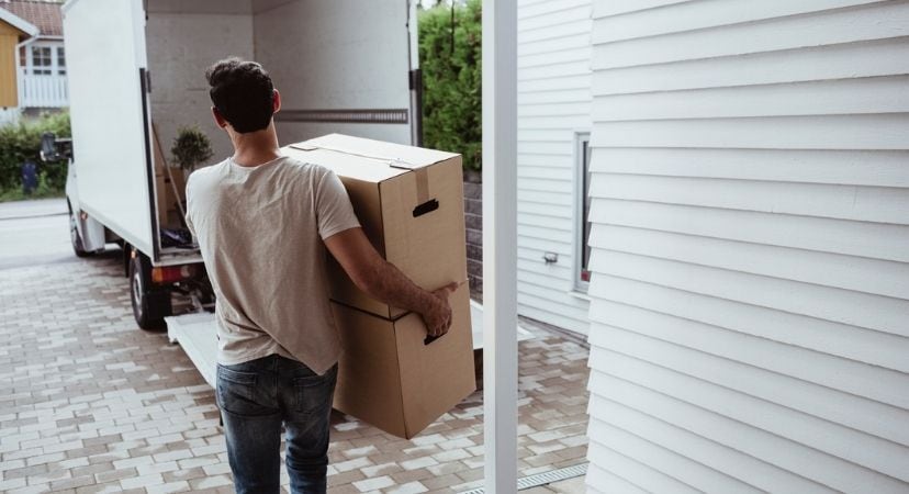 Wondering What to Pack First When Moving? We've Got Your Answers Person carrying a moving box to their moving truck
