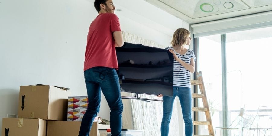 Couple carrying a TV - moving