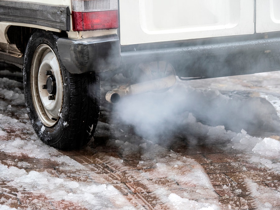 Close-up of car exhaust pipe with carbon monoxide coming out of the exhaust. Close-up of car exhaust pipe with carbon monoxide coming out of the exhaust.