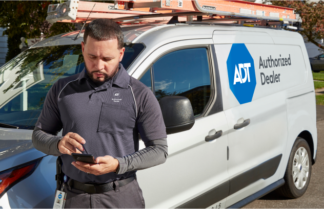 ADT installer next to van