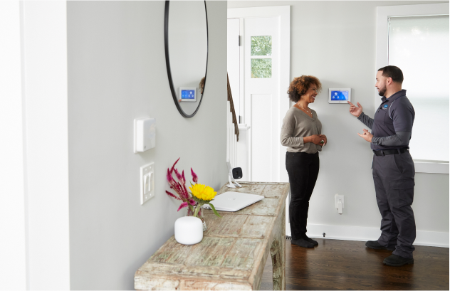 ADT installer and customer in her home ADT installer and customer in her home