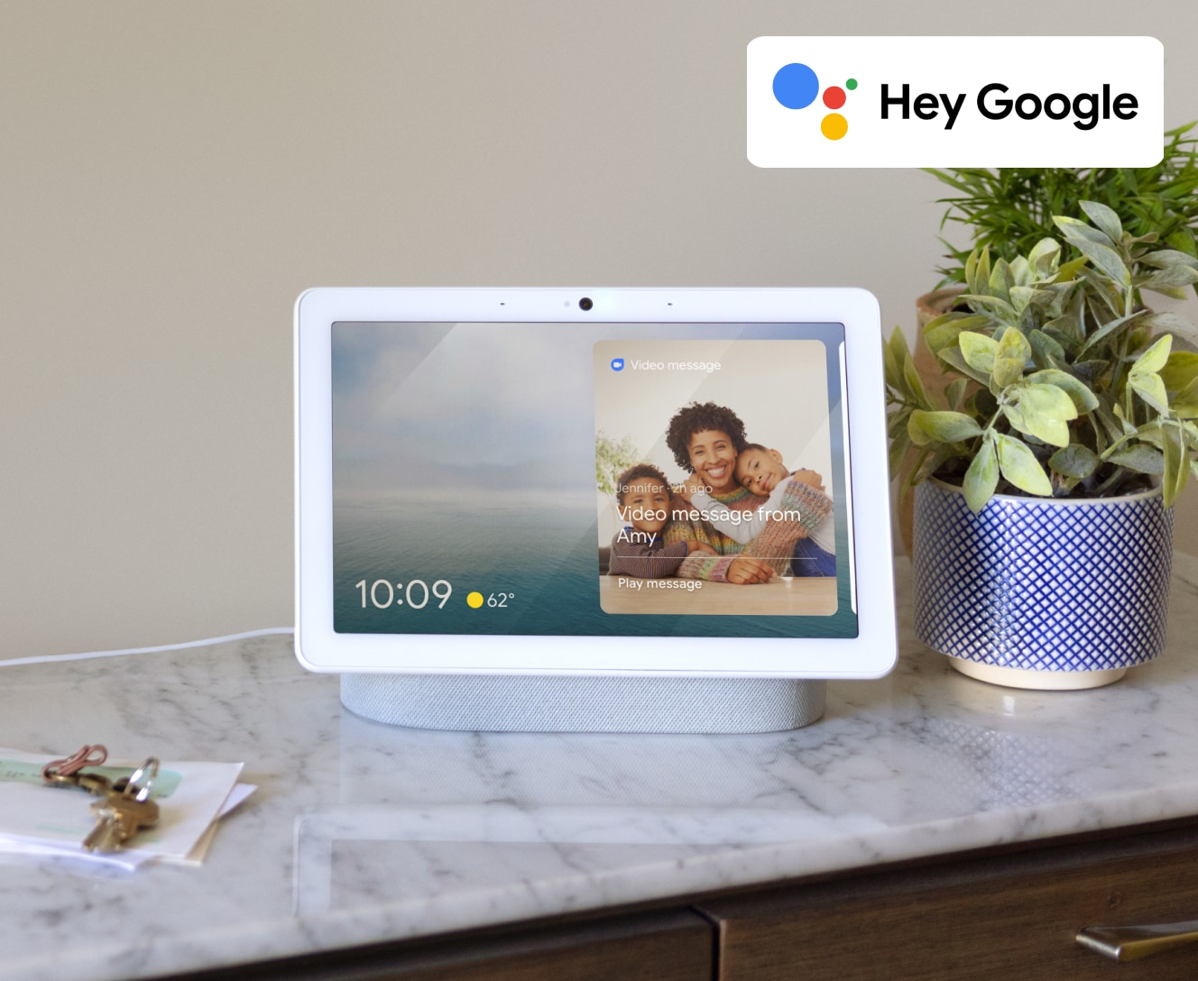 Google Nest Hub (2nd Gen) on a counter next to a plant Google Nest Hub (2nd Gen) on a counter next to a plant