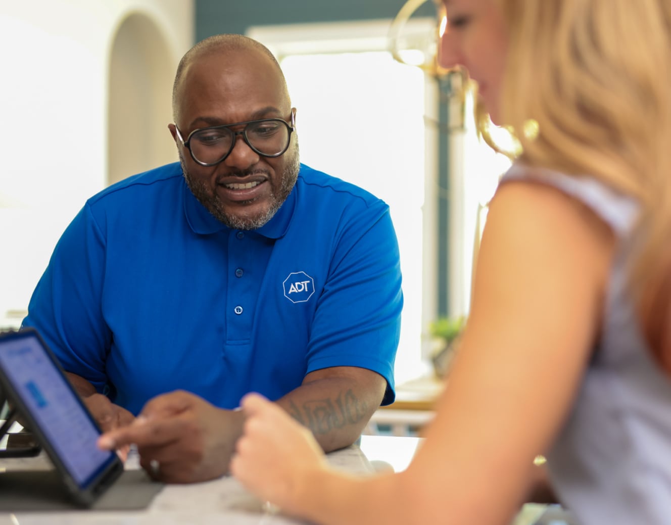 ADT installer consulting with a customer for her ADT protected home ADT installer consulting with a customer for her ADT protected home