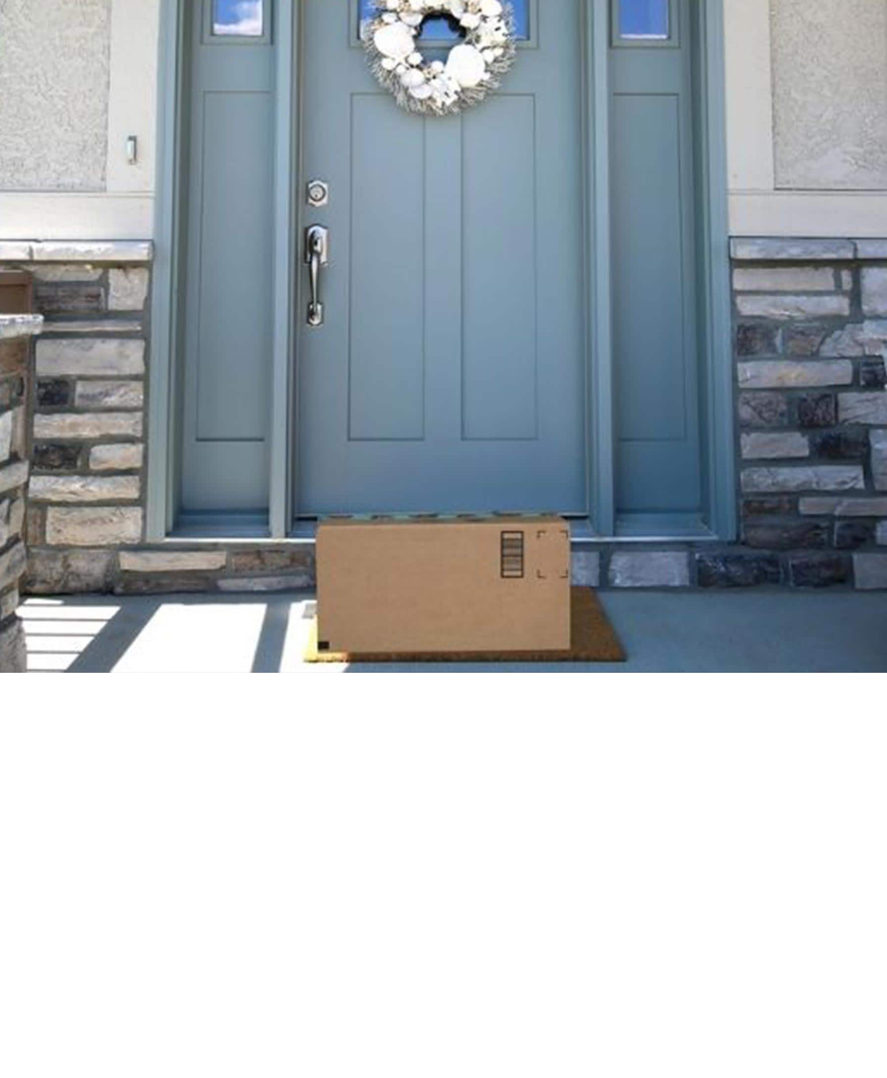 Family moving into a new home - carrying boxes and toys