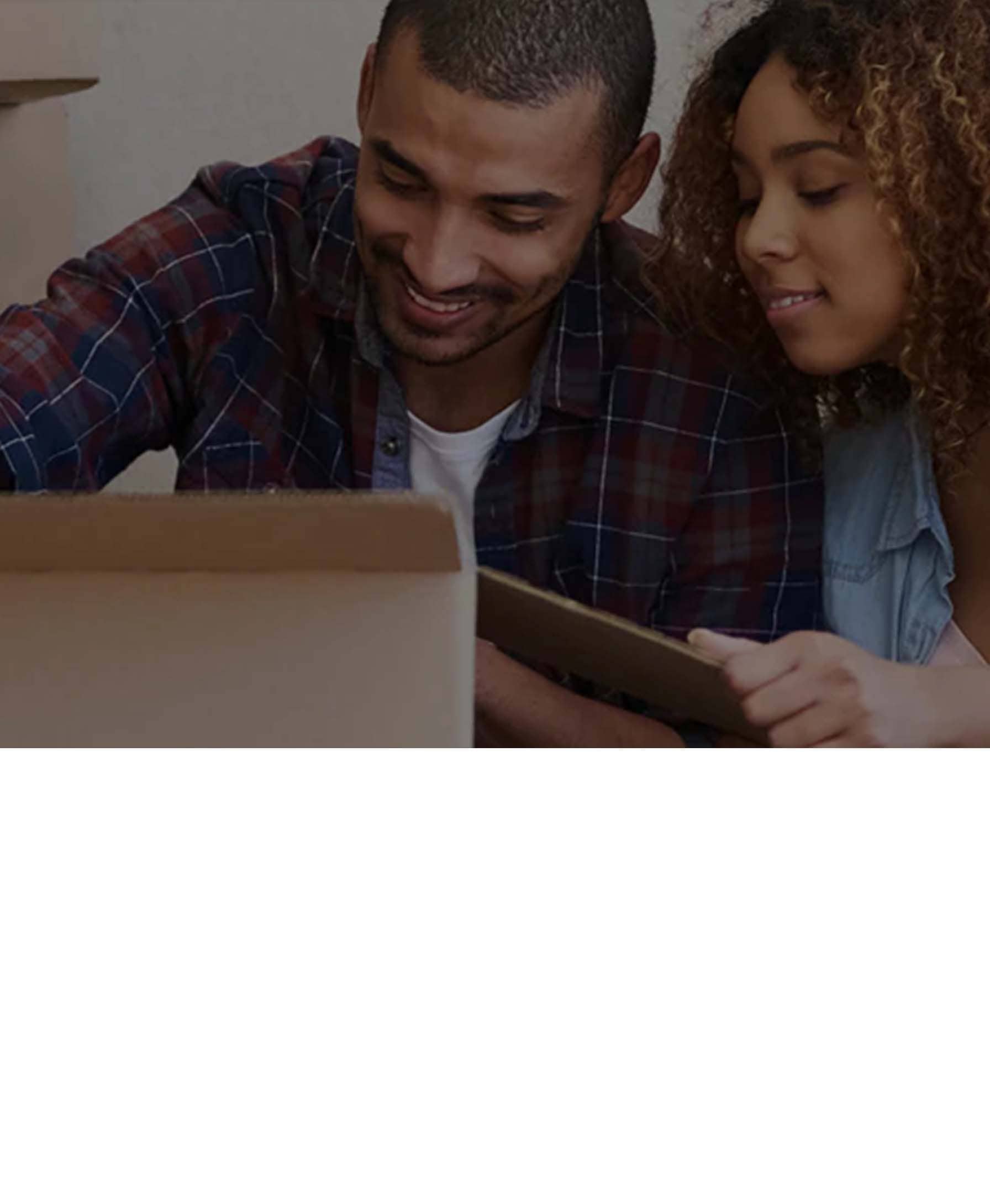 Family moving into a new home - carrying boxes and toys