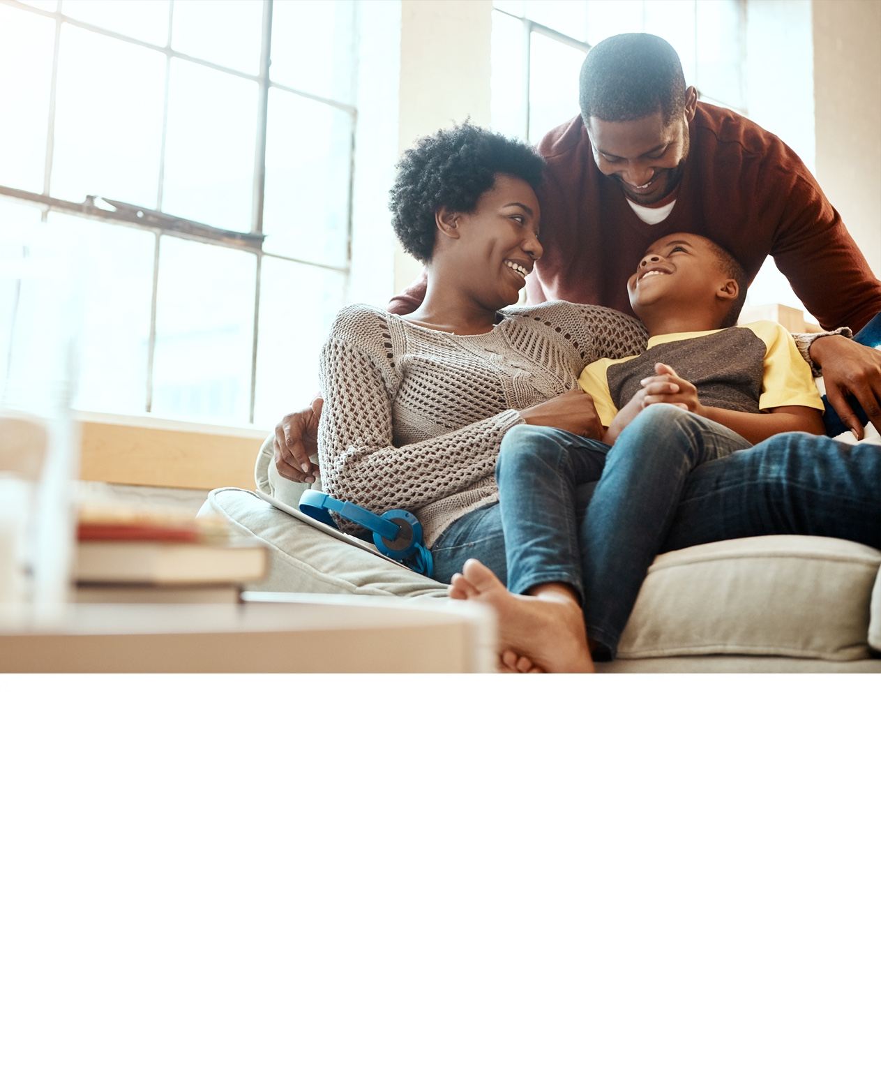 Happy family sitting together at home smiling