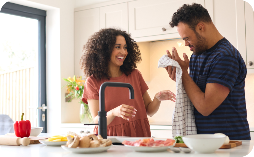 Couple preparing food together in a bright modern kitchen
