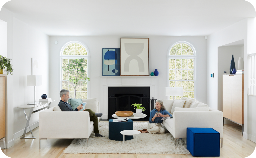 Family relaxing in a spacious living room with large windows and modern decor