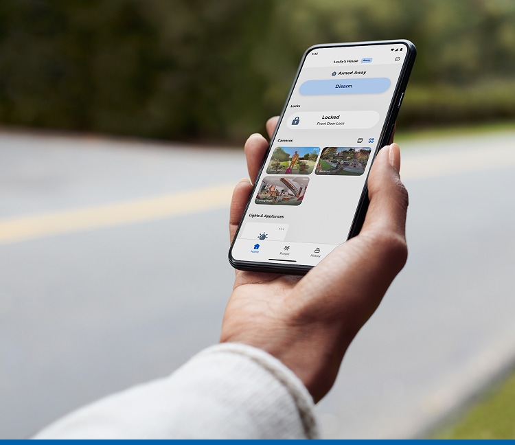 Hand holding a cell phone showing the ADT Plus App