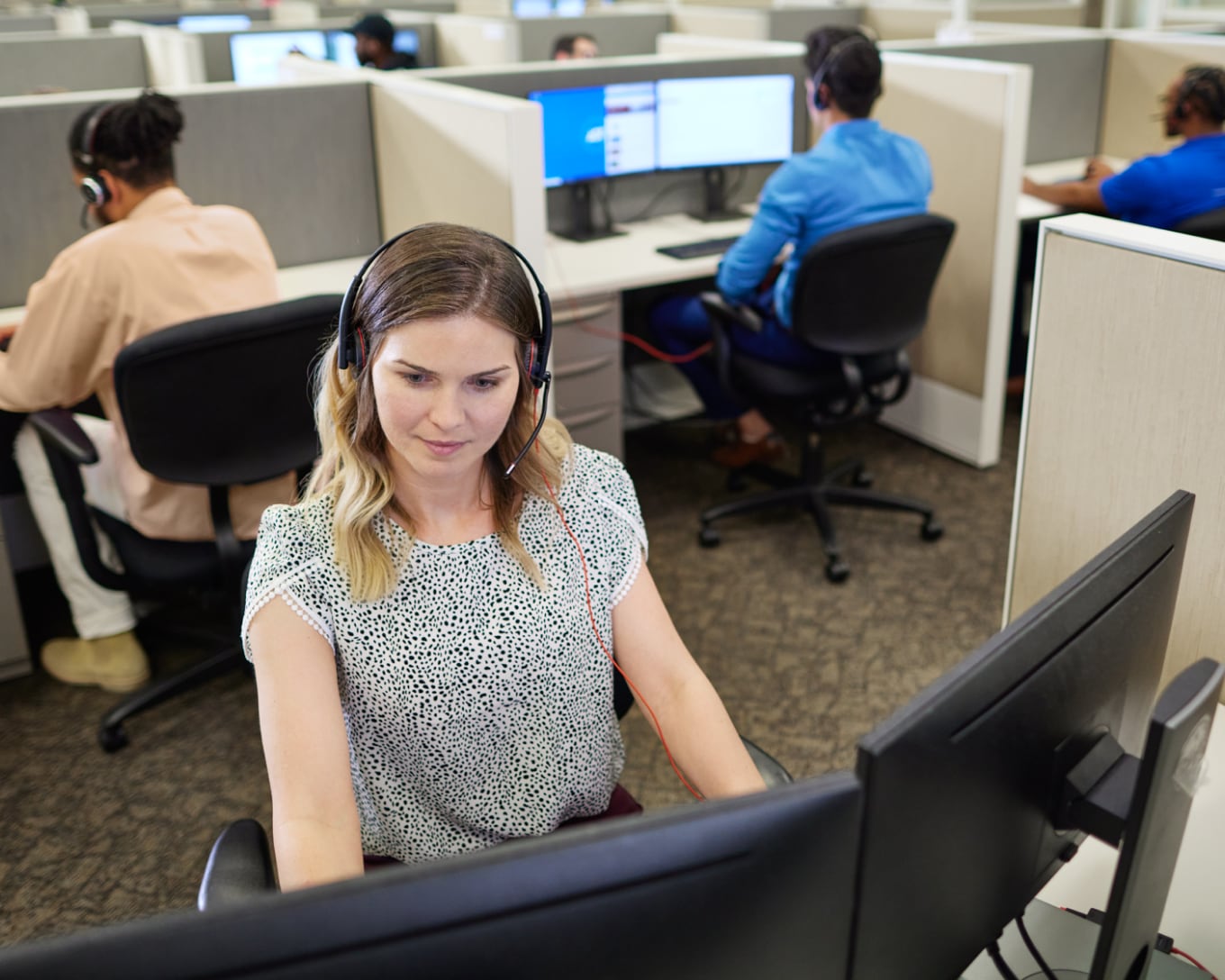 ADT call center employee smiling and talking into a headset 