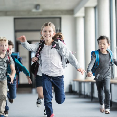 School children running toward camera