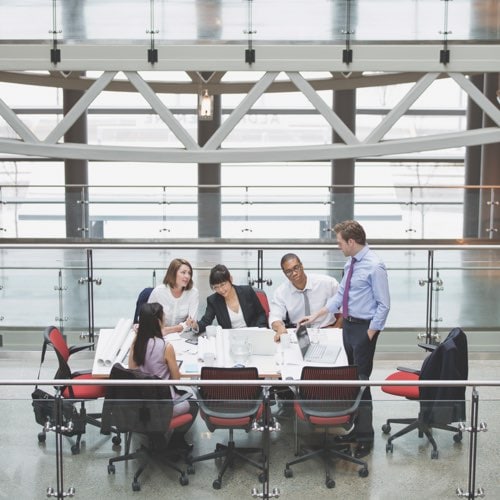 Business meeting on skyway in atrium